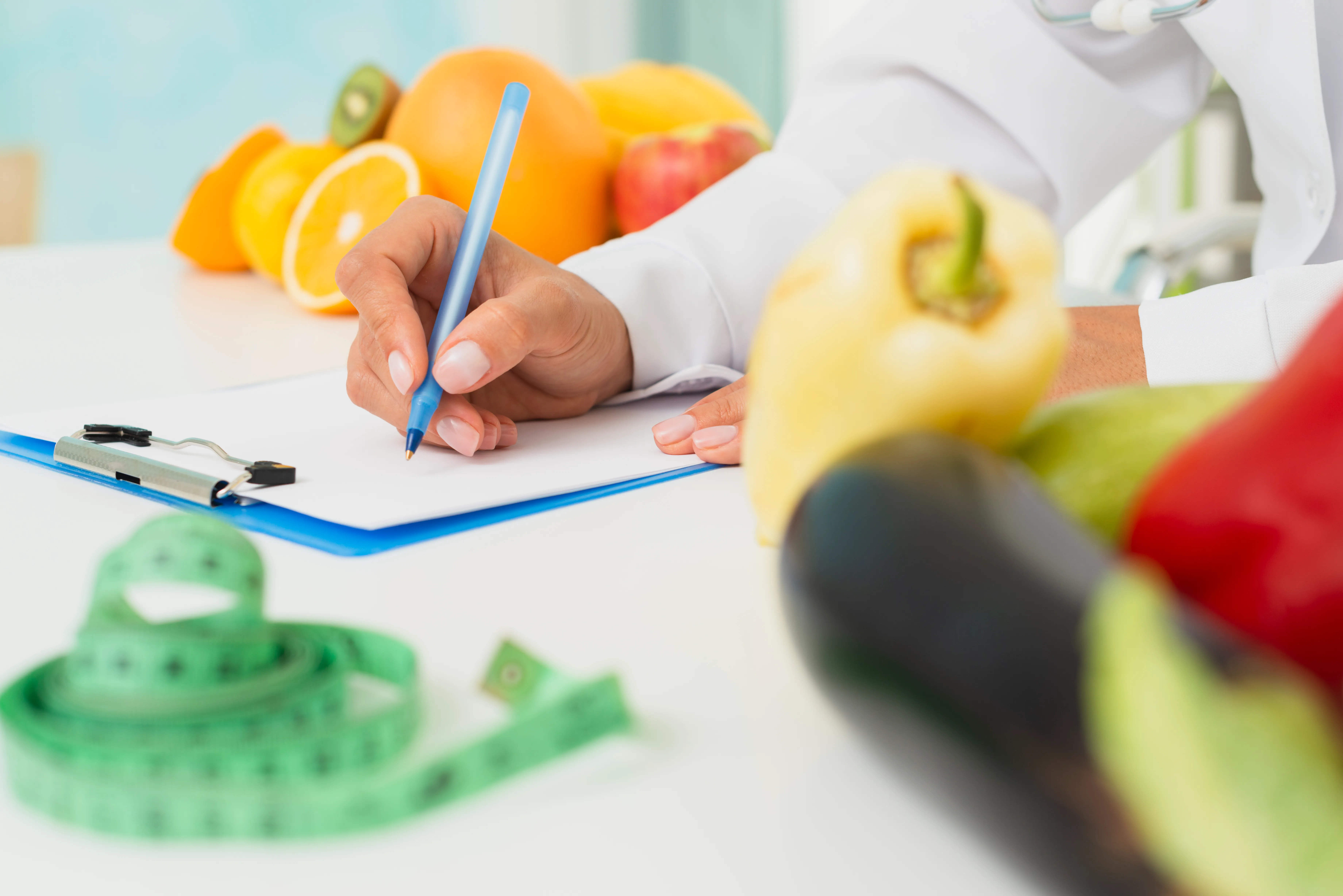 close up nutritionist writing prescription